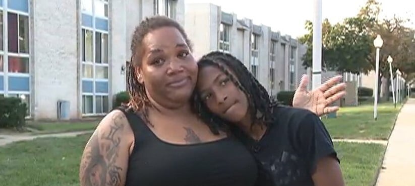 Boy with head on the shoulder of his mother 